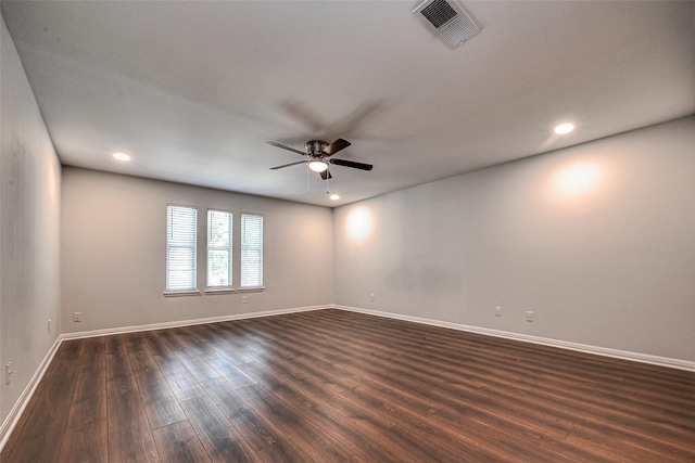 empty room featuring baseboards, visible vents, a ceiling fan, dark wood-style flooring, and recessed lighting