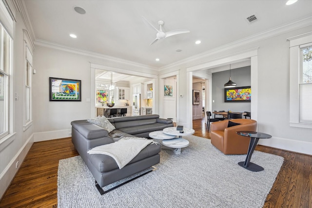 living room featuring baseboards, visible vents, dark wood-style floors, crown molding, and recessed lighting