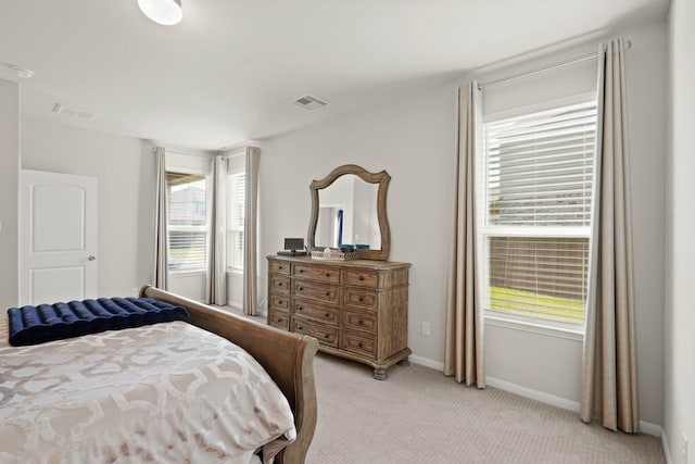 bedroom featuring light carpet, baseboards, and visible vents