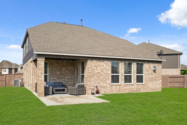 rear view of house with a patio area, a fenced backyard, brick siding, and a yard