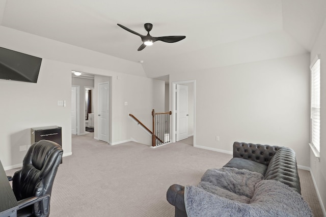 home office featuring lofted ceiling, light carpet, baseboards, and a wealth of natural light