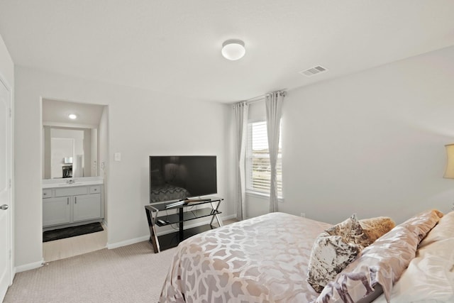 bedroom featuring visible vents, light carpet, and baseboards