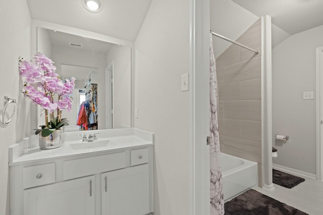 full bath with baseboards, lofted ceiling, vanity, and shower / tub combo with curtain