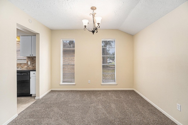 unfurnished dining area featuring light colored carpet, a notable chandelier, a textured ceiling, and baseboards