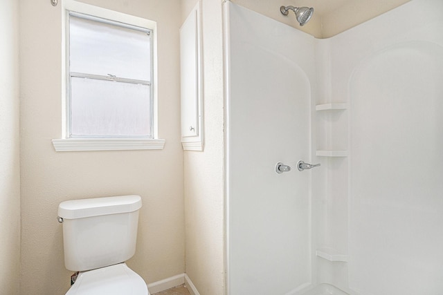 bathroom featuring baseboards and toilet