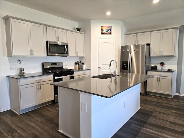 kitchen with dark countertops, appliances with stainless steel finishes, and a sink