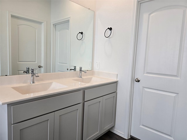 full bathroom featuring a sink and double vanity