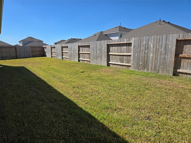 view of yard with a fenced backyard