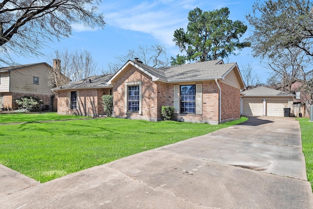 view of front facade featuring a garage, brick siding, an outdoor structure, and a front lawn