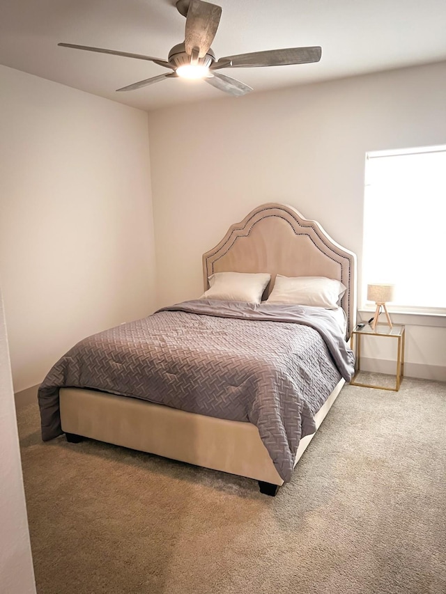 bedroom with carpet floors, a ceiling fan, and baseboards