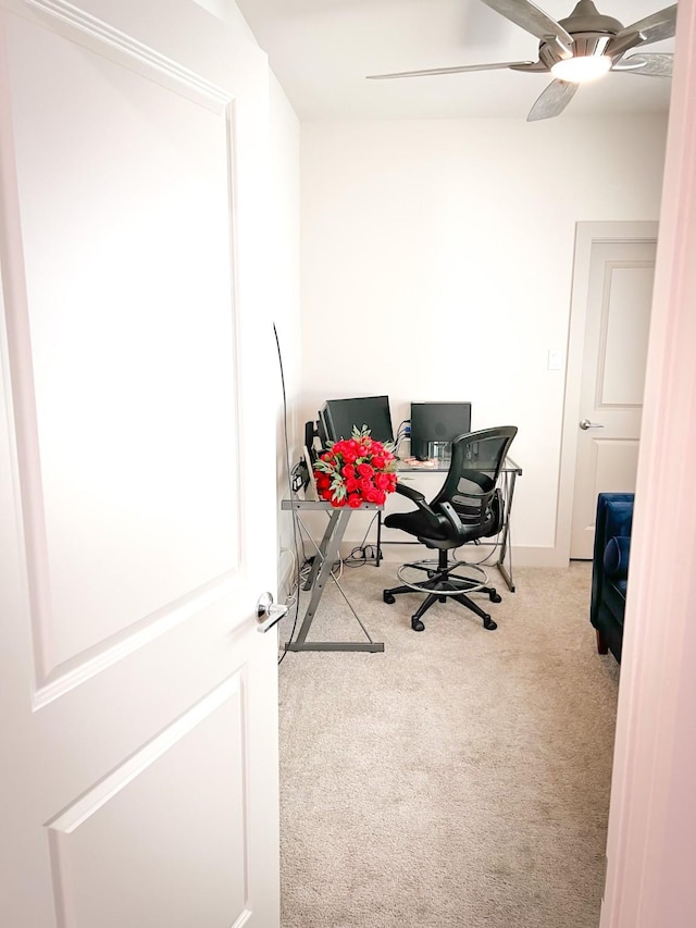 home office featuring ceiling fan and light colored carpet