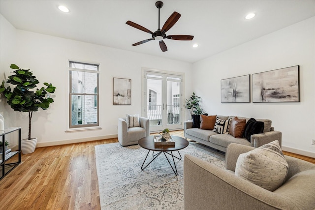 living area featuring recessed lighting, french doors, a healthy amount of sunlight, and light wood-style flooring