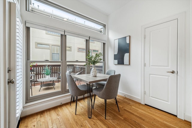 dining room featuring light wood-style floors and baseboards