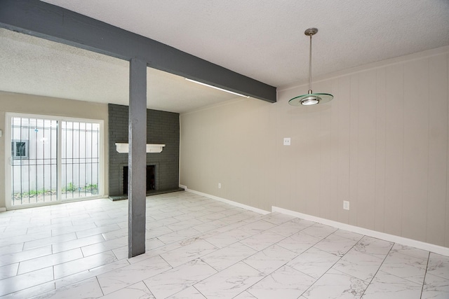 interior space with marble finish floor, a brick fireplace, a textured ceiling, beamed ceiling, and baseboards