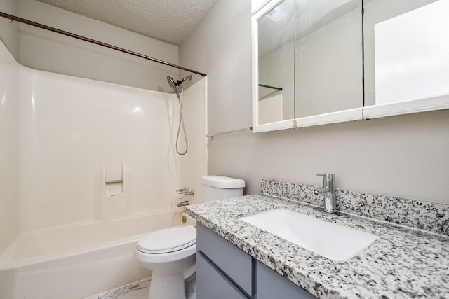 full bathroom with a textured ceiling, toilet, bathtub / shower combination, and vanity