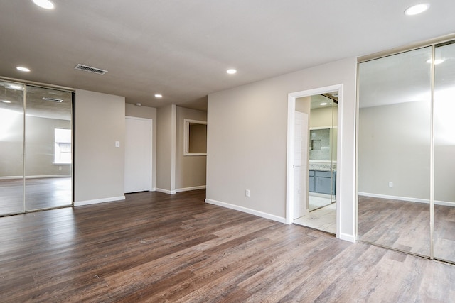 interior space featuring baseboards, dark wood finished floors, visible vents, and recessed lighting