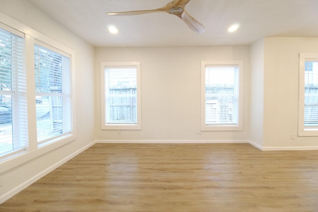 empty room with light wood-style flooring, baseboards, a ceiling fan, and recessed lighting