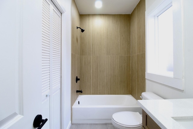 bathroom featuring toilet, tile patterned flooring, vanity, washtub / shower combination, and a closet