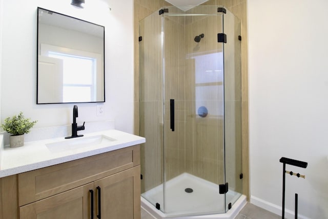 full bath with a shower stall and vanity