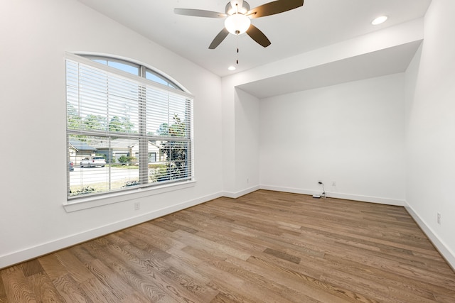 empty room featuring a ceiling fan, light wood-type flooring, baseboards, and recessed lighting