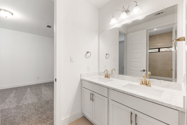 full bath with double vanity, a sink, visible vents, and baseboards