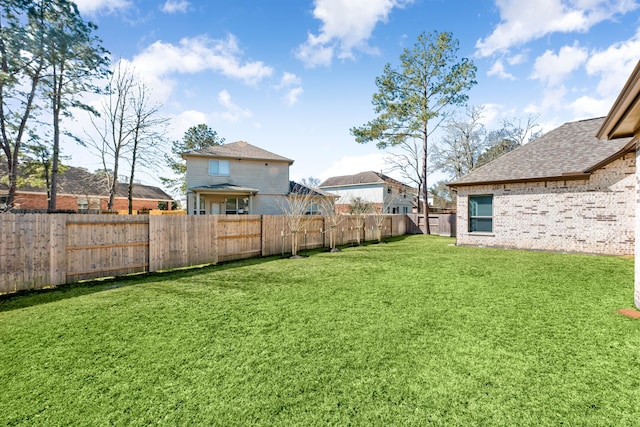 view of yard with a fenced backyard