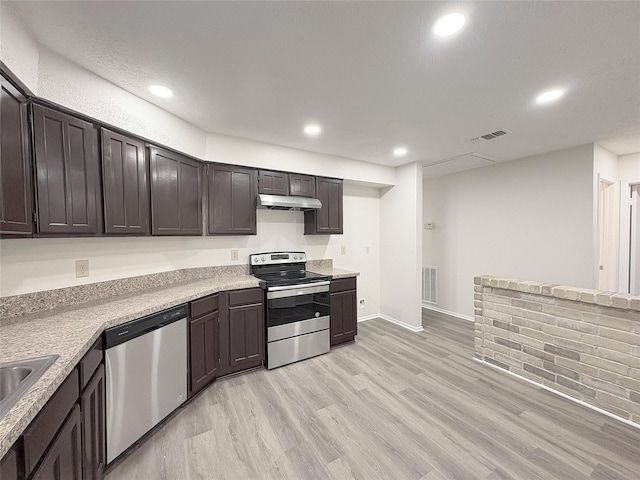 kitchen with stainless steel appliances, dark brown cabinets, light wood-style flooring, and visible vents