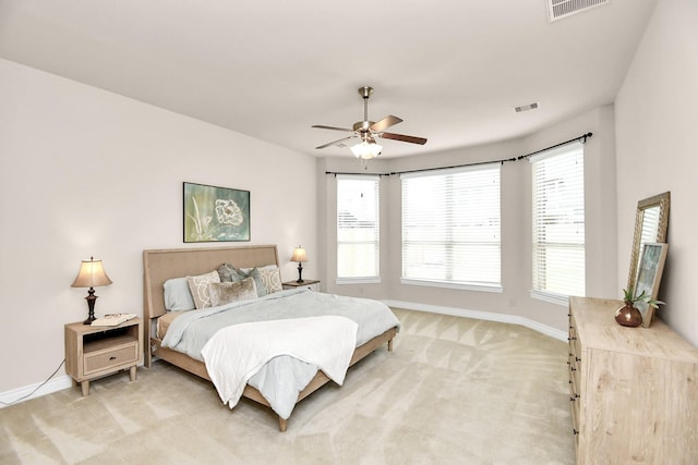 bedroom featuring baseboards, light colored carpet, and a ceiling fan