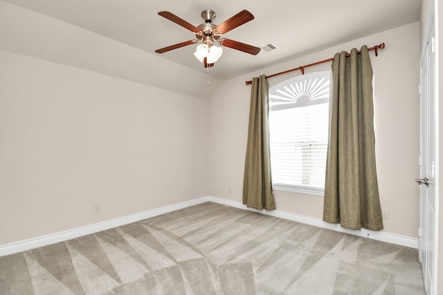 spare room with ceiling fan, baseboards, light colored carpet, and lofted ceiling