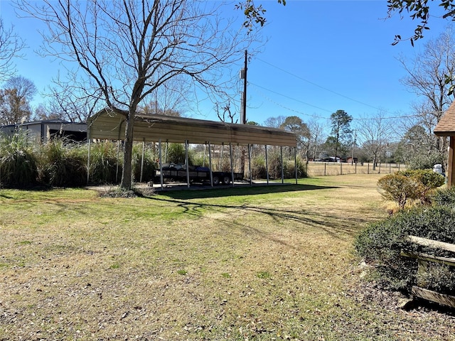 view of yard with a detached carport and fence