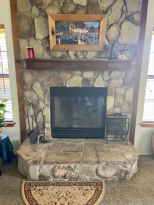 interior details featuring carpet floors and a fireplace