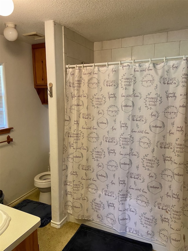 bathroom featuring a shower with curtain, visible vents, a textured ceiling, and vanity