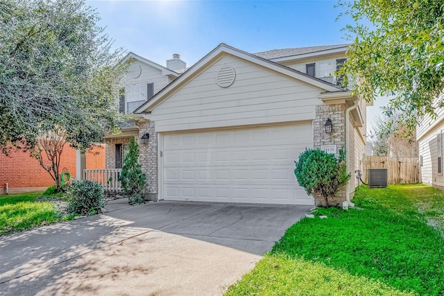 view of front facade with an attached garage, central AC unit, fence, driveway, and a front lawn