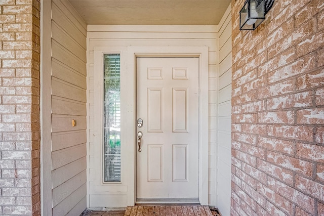 entrance to property with brick siding