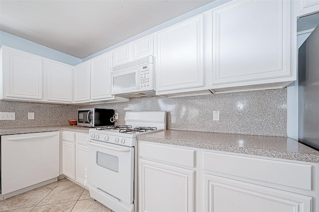 kitchen with tasteful backsplash, white appliances, light countertops, and white cabinets