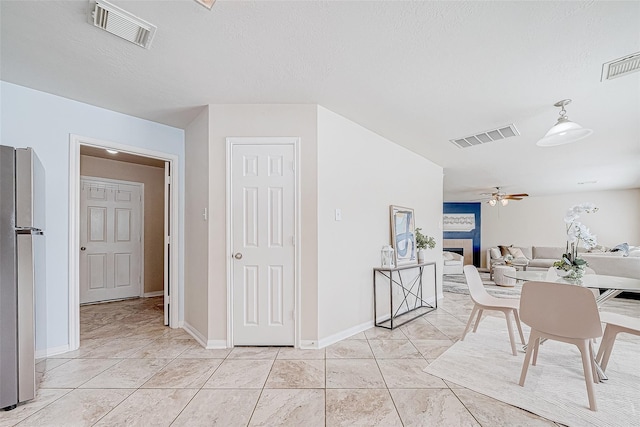 interior space featuring baseboards, visible vents, and a textured ceiling