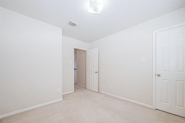 empty room with light carpet, baseboards, and visible vents