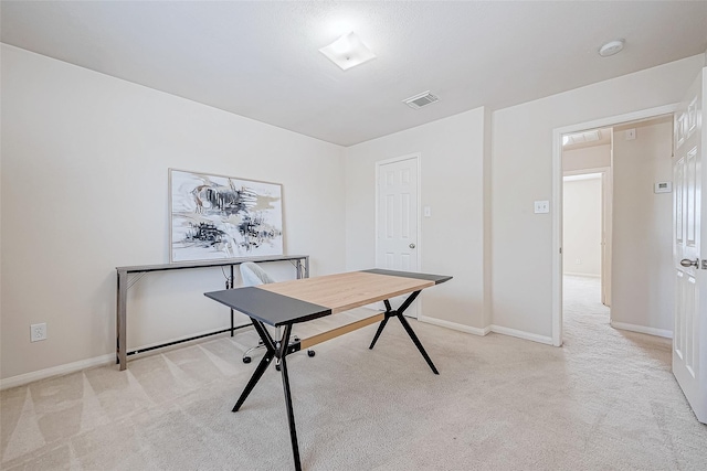 office featuring light colored carpet, visible vents, and baseboards