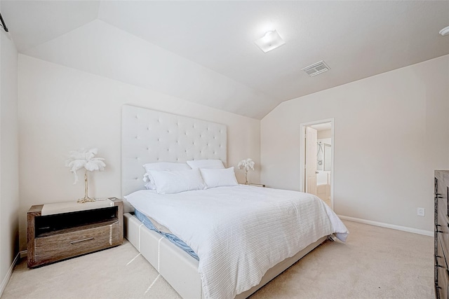 bedroom with light carpet, baseboards, visible vents, connected bathroom, and vaulted ceiling