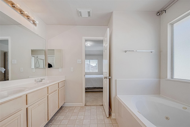 ensuite bathroom with a healthy amount of sunlight, ensuite bath, visible vents, and a whirlpool tub