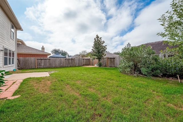 view of yard with a fenced backyard