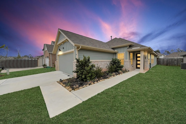 view of front facade featuring driveway, an attached garage, fence, a yard, and board and batten siding