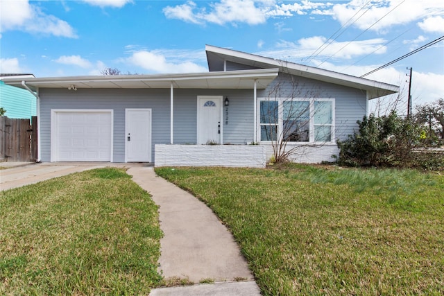 view of front of house featuring a garage, driveway, a front yard, and fence