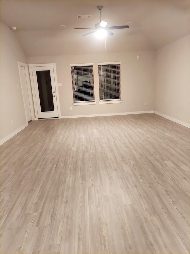 unfurnished room featuring ceiling fan, light wood-type flooring, visible vents, and baseboards