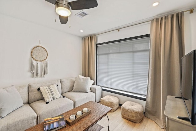 living area with recessed lighting, visible vents, ceiling fan, and wood finished floors