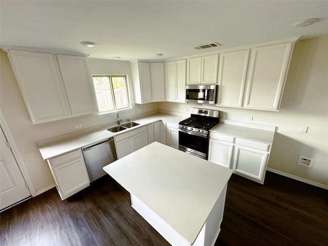 kitchen featuring a sink, stainless steel appliances, light countertops, and white cabinetry