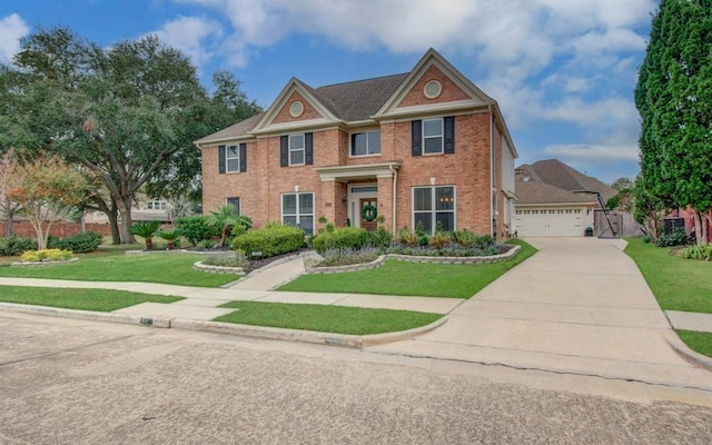 view of front of property with a garage, brick siding, a front lawn, and fence