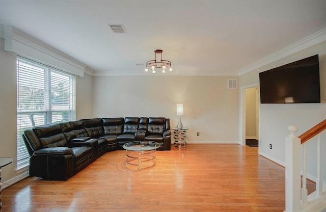 living room with visible vents, crown molding, baseboards, and wood finished floors