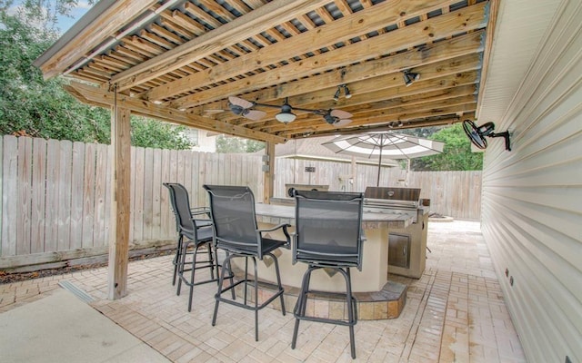 view of patio / terrace featuring outdoor dining area, a fenced backyard, and a ceiling fan