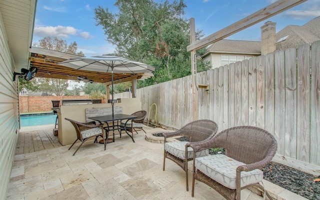 view of patio with a fenced backyard, a fenced in pool, and outdoor dining space